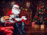 Father Christmas sat in front of a Christmas tree with a bag full of wonderful presents