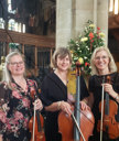  women stood in church holding their wood instruments