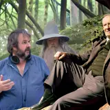 three men sat at bottom of tree one wearing a wizard's hat!