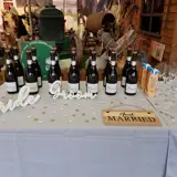 champagne bottles and just married sign on table