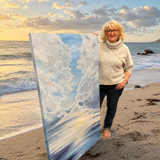 artist should with a piece of her artwork that replicates her location of the sea and sand with bright cloudy sky with a cloud break