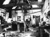 black and white old photo of dilapidated workshop