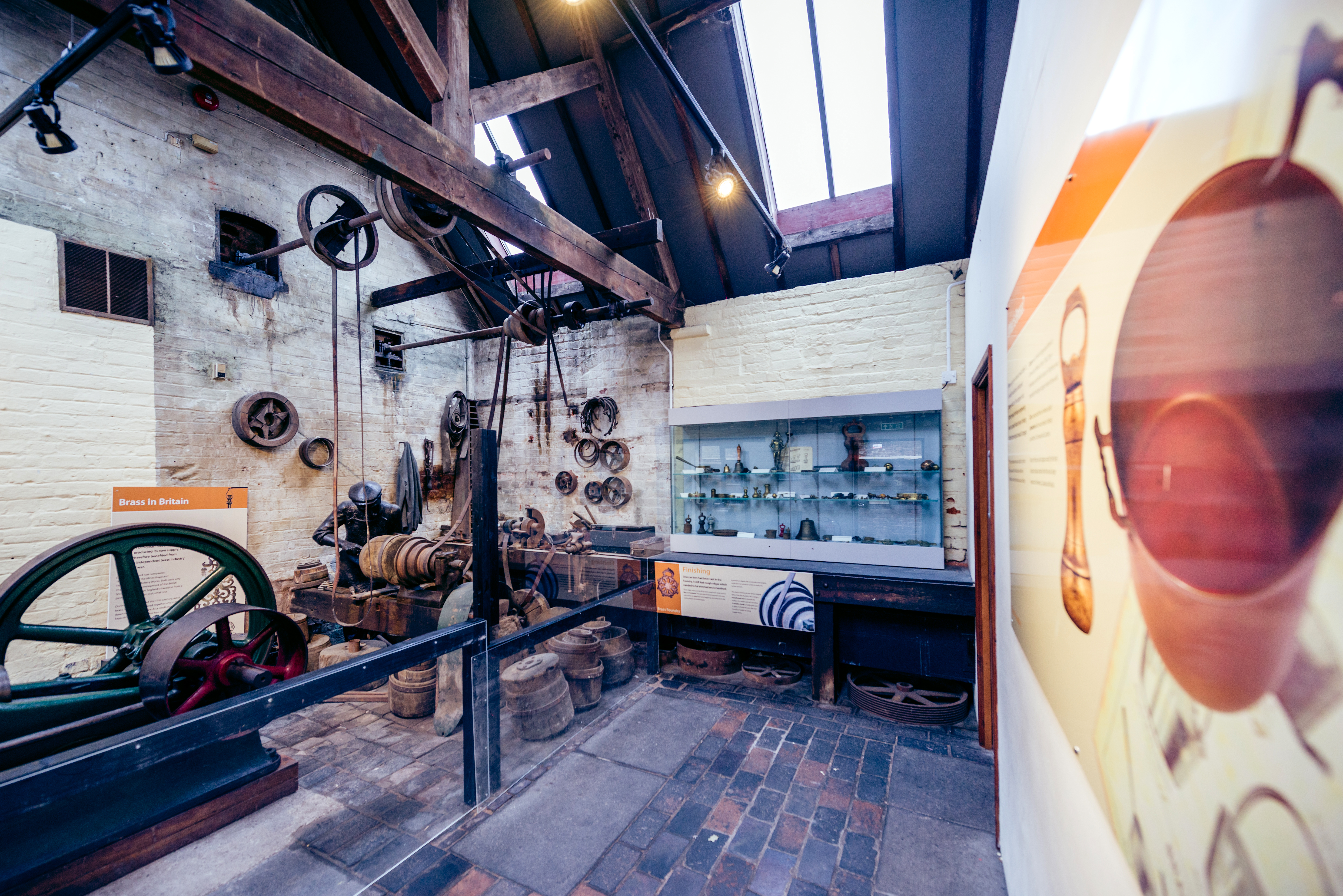 exhibition of former brass foundry with large information boards text unreadable on image
